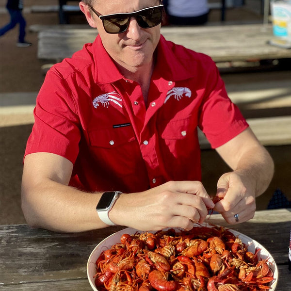 Mike Wearing his Crawdaddy Pearl Snap Shirt eating some Crawfish